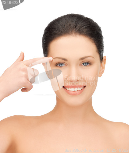 Image of woman touching her face skin