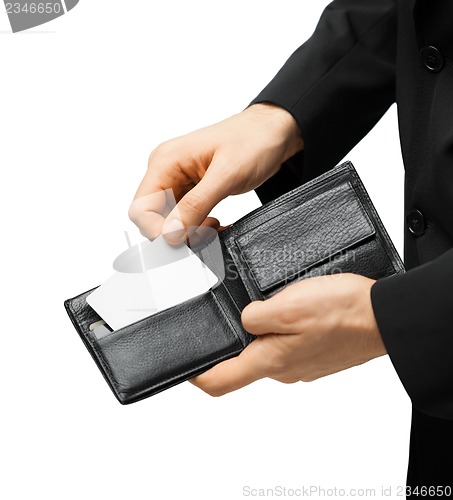 Image of man in suit holding credit card