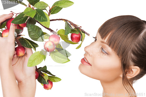 Image of lovely woman with apple twig