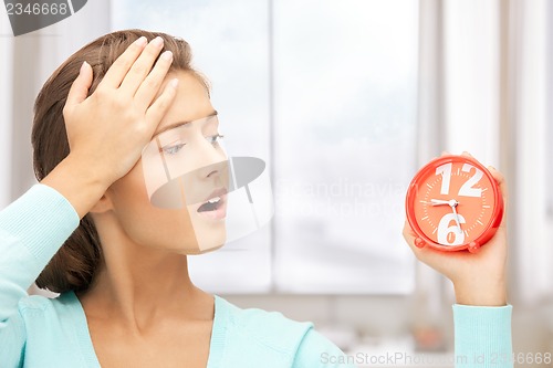 Image of woman holding alarm clock