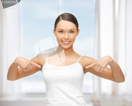Image of woman in blank white t-shirt pointing at herself
