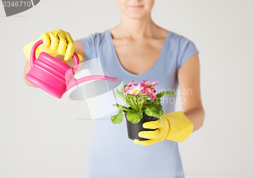 Image of woman holding pot with flower