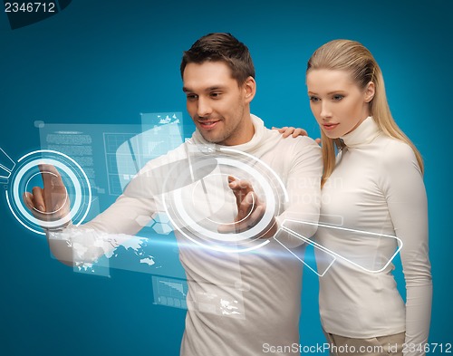 Image of man and woman working with virtual screens