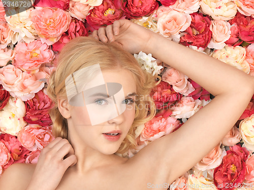 Image of beautiful woman and background full of roses