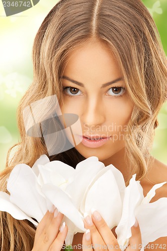 Image of lovely woman with lily flower and butterflies