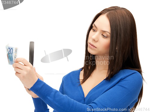 Image of woman with magnifying glass and euro cash money