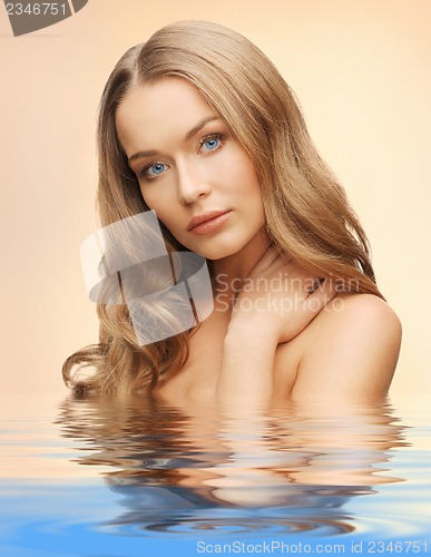 Image of beautiful woman with long hair in water