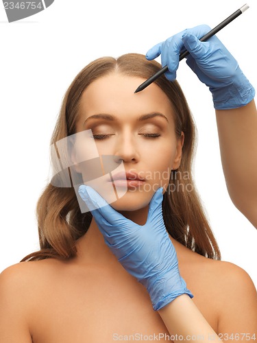 Image of woman face and beautician hands
