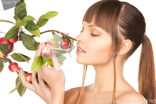 Image of lovely woman with apple twig