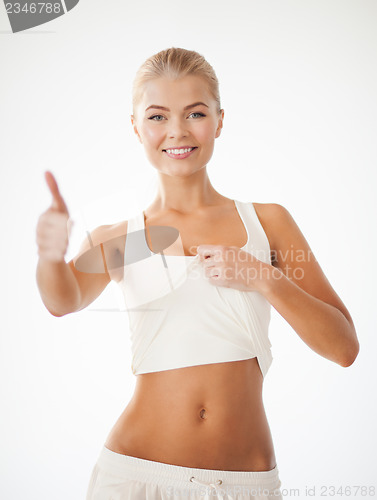 Image of sporty woman showing thumbs up