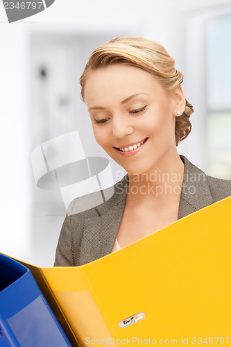 Image of smiling woman with folders
