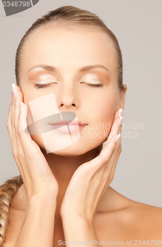 Image of face and hands of beautiful woman