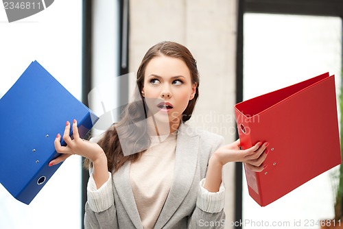 Image of unsure thinking or wondering woman with folder