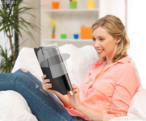 Image of woman with tablet pc computer or touchpad indoors