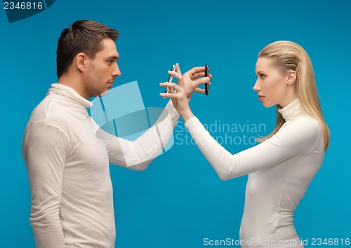 Image of man and woman with modern gadgets