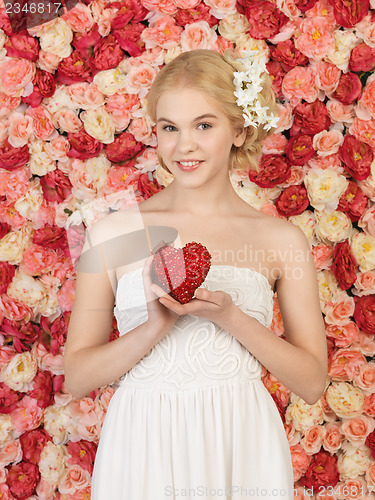 Image of woman with heart and background full of roses