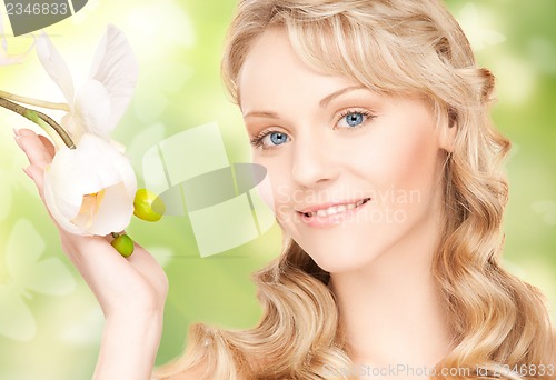 Image of beautiful woman with orchid flower and butterflies