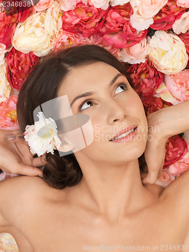 Image of beautiful woman and background full of roses