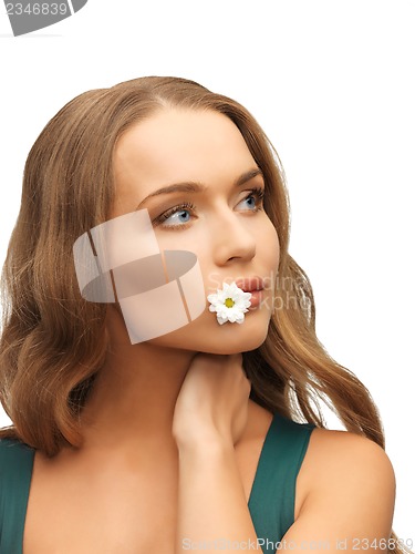 Image of woman with camomile in mouth