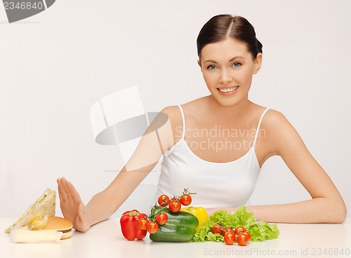 Image of woman with hamburger and vegetables