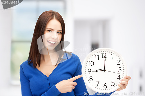 Image of woman holding big clock