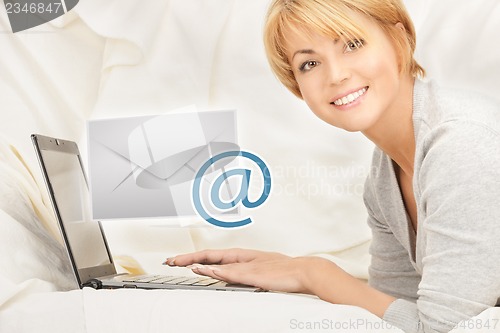 Image of woman with laptop computer sending e-mail