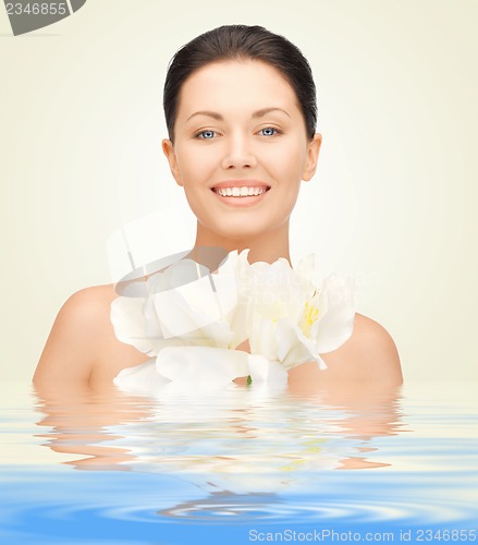 Image of woman with orchid flower in water