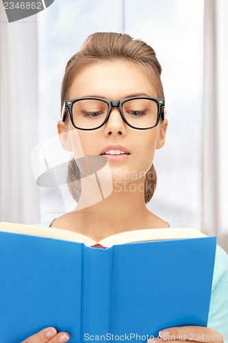 Image of calm and serious woman with book