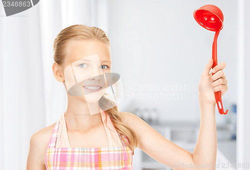 Image of little housewife with red ladle at kitchen