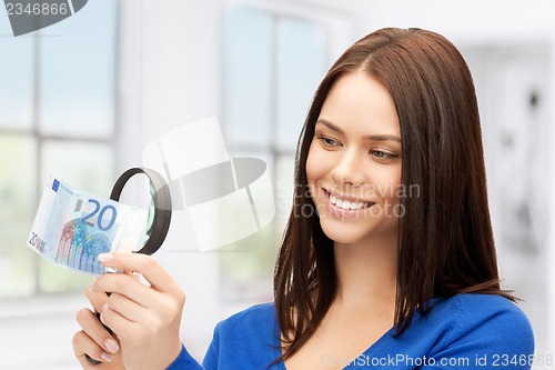 Image of woman with magnifying glass and euro cash money