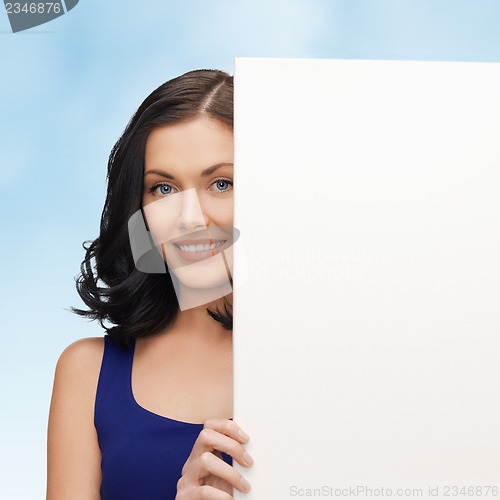 Image of lovely woman in blue dress with blank board