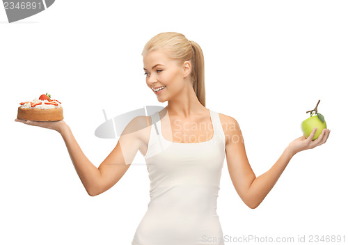 Image of sporty woman with apple and cake