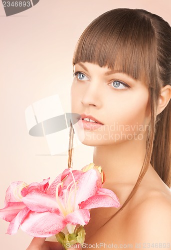 Image of lovely woman with red lily flower