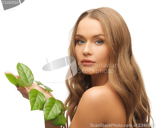 Image of woman with green leaf