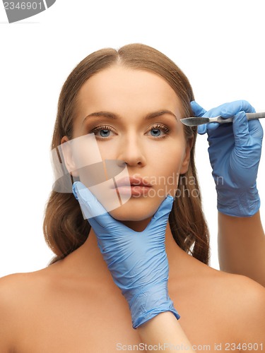 Image of woman face and beautician hands