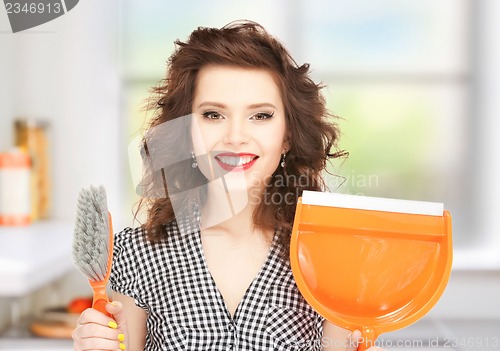 Image of beautiful woman with brush and pan