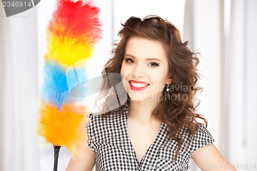 Image of beautiful woman with cleaning sweep