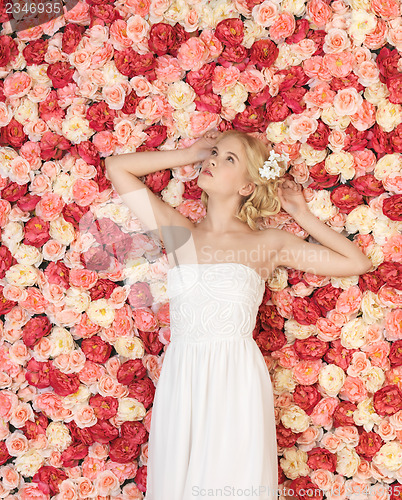 Image of young woman with background full of roses