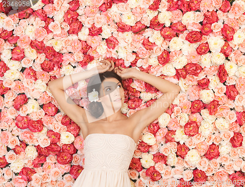 Image of young woman with background full of roses