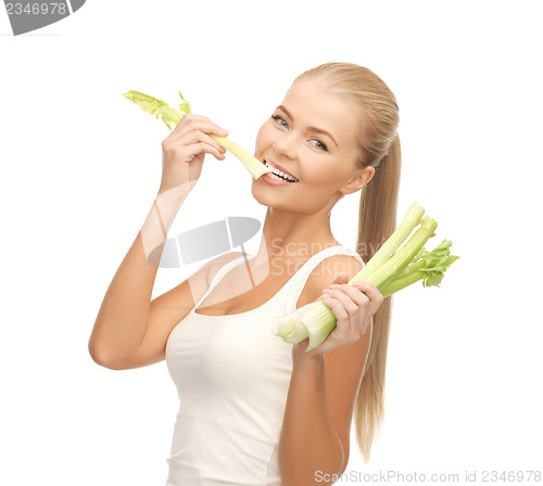 Image of woman biting piece of celery or green salad