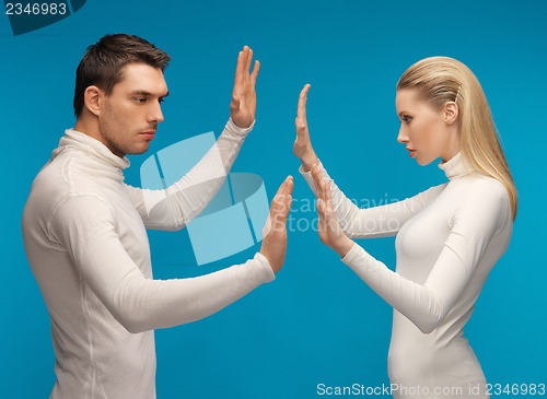 Image of man and woman working with something imaginary