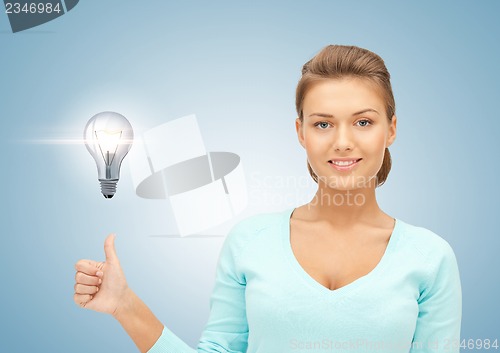 Image of woman with light bulb showing thumbs up