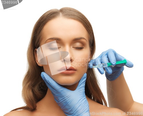 Image of woman face and beautician hands