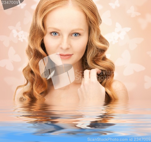 Image of beautiful woman with butterflies in water