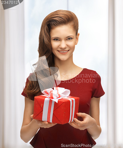Image of teenage girl in red dress with gift box