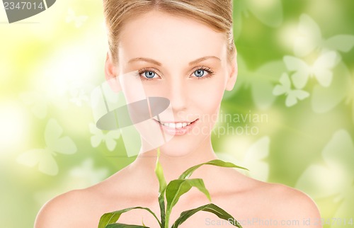 Image of woman with sprout and butterflies