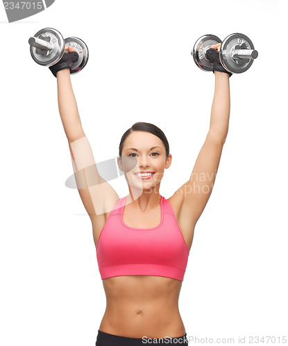 Image of woman with heavy steel dumbbells