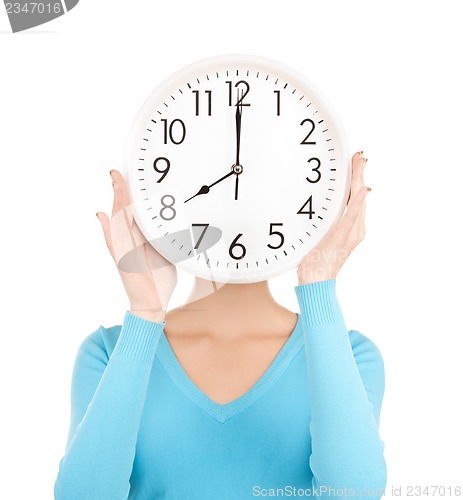 Image of businesswoman with clock over her face