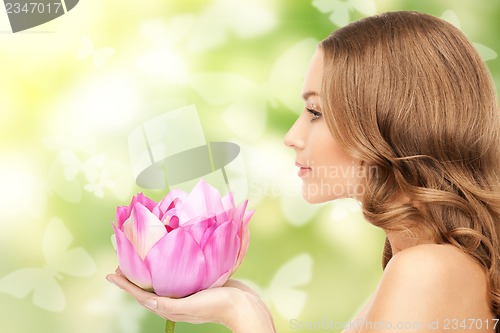 Image of beautiful woman with lotus flower and butterflies