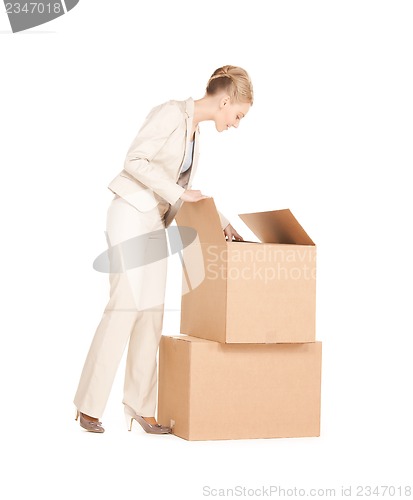 Image of businesswoman unpacking big boxes